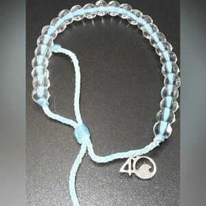 4Ocean Delicate Clear and Light Blue Beaded Bracelet pull tie bracelet.